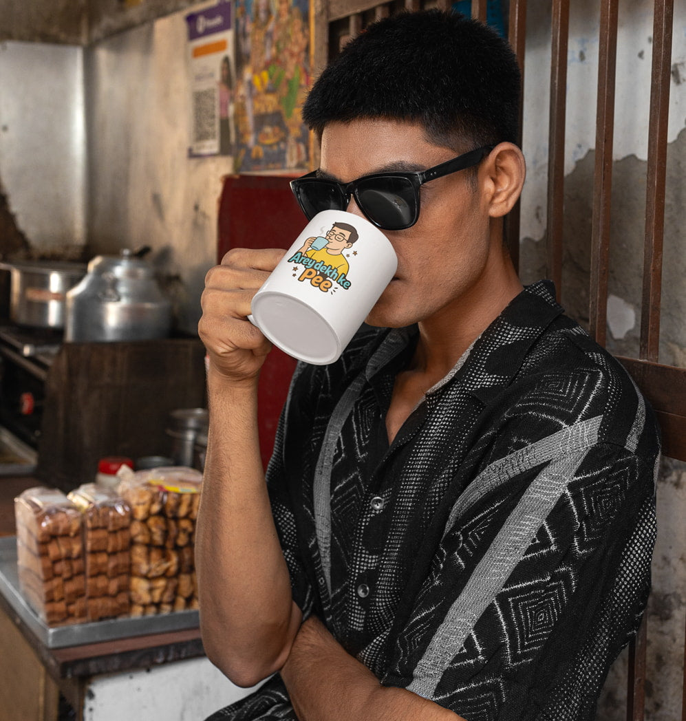 Funny chai mug with Hindi phrase "Arey Dekh Ke Pee" and cartoon character.