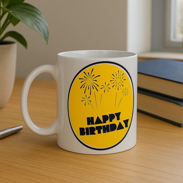 birthday-mug-lifestyle-desk Close-up of the "Happy Birthday" celebration design on a white ceramic mug, perfect for gifting